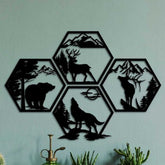 Iron Hexagon Forest Animal Wall Art Set on green wall, 4-piece black metal artwork with bear, deer, elk, and wolf silhouettes for nature-inspired home decor.