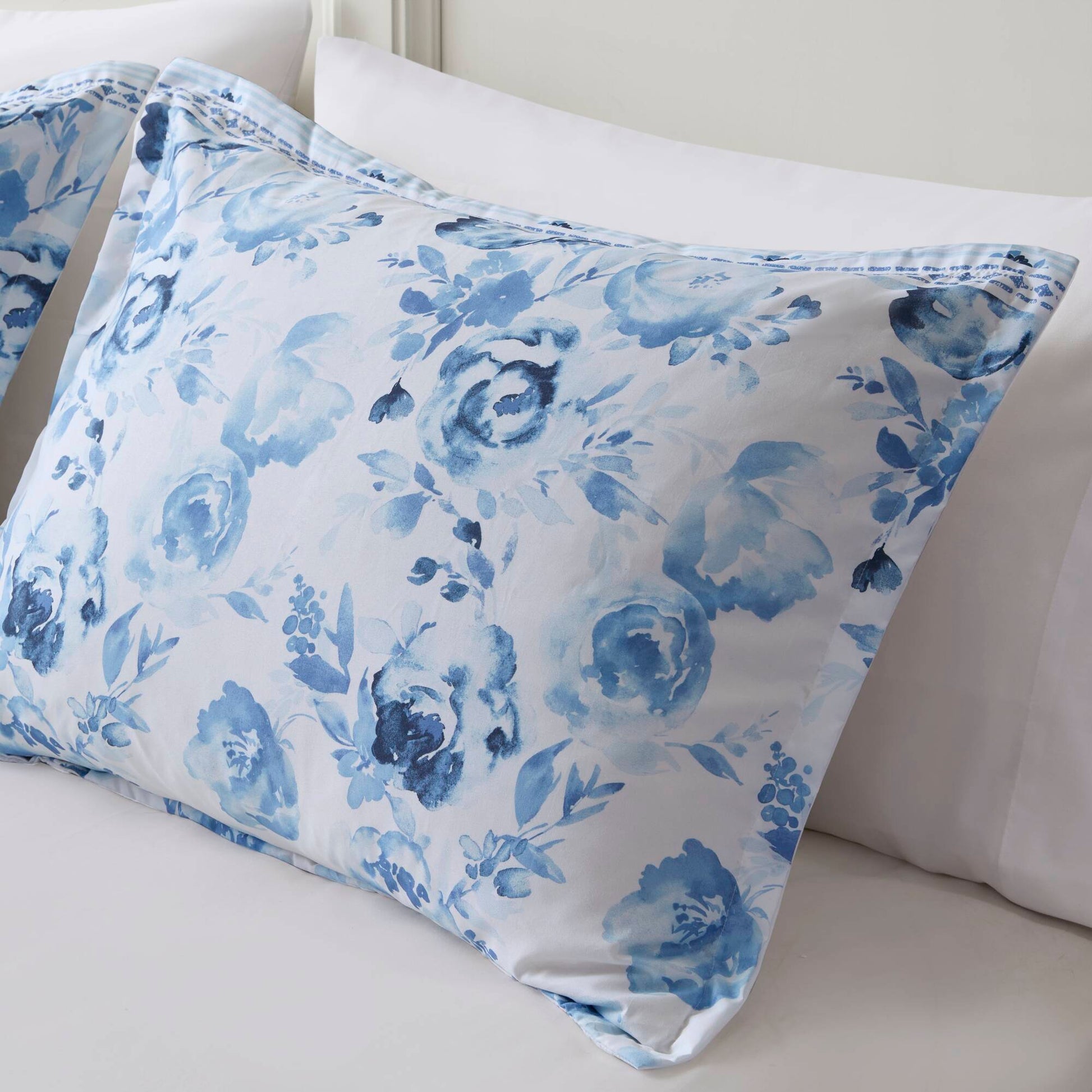 Close-up of floral pillow sham from the Twin Floral Striped Duvet Cover Set - Twin Duvet Cover Set Floral, featuring soft blue watercolor roses.
