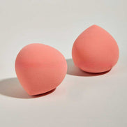 Two peach-toned beauty blenders from the Pink Crystal Makeup Set designed for precise, streak-free makeup application without product waste.