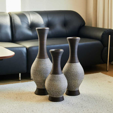 Brown floor vase set of 3 displayed in a living room with black sofa, perfect for modern interiors and floral arrangements.