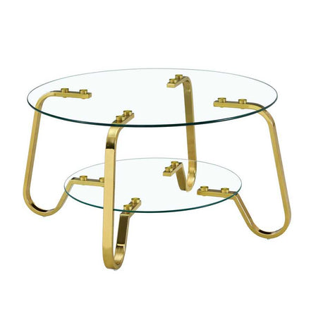 Freestanding vintage metal coffee table with round glass top and bottom shelf, gold curved legs for modern appeal.