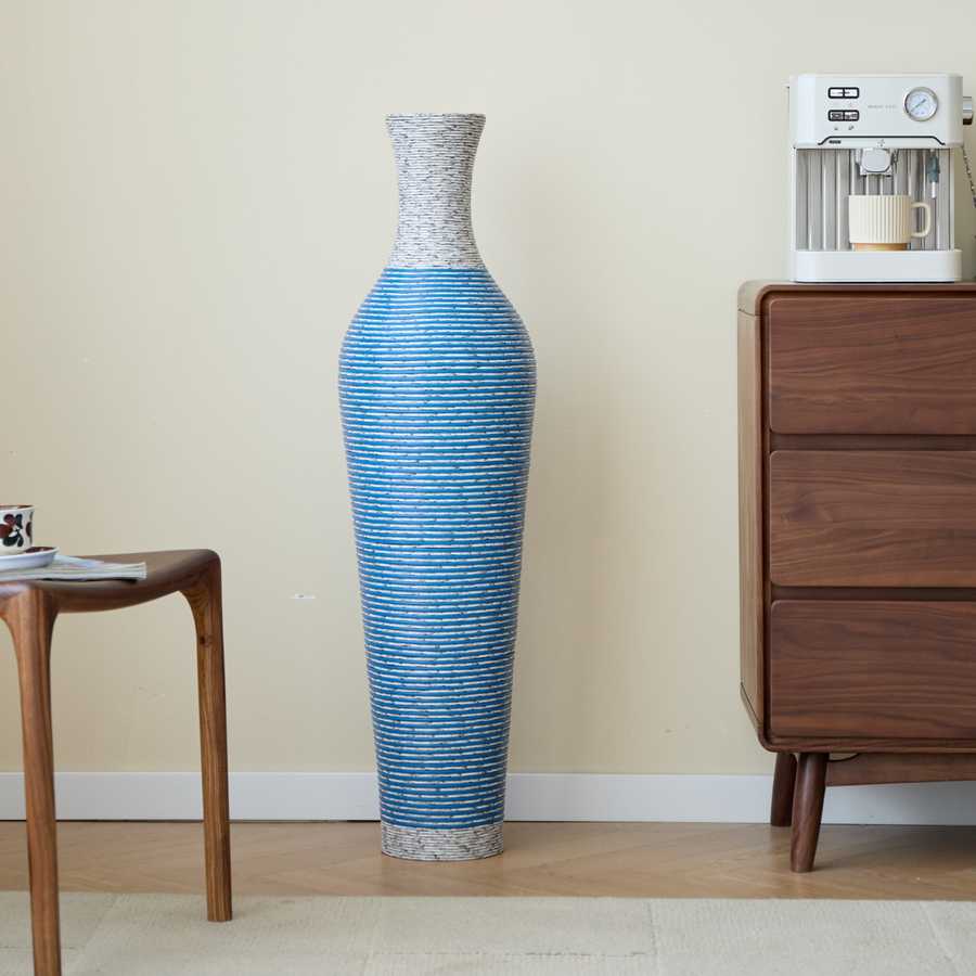 Blue 39-inch floor vase decor next to a wooden dresser and coffee machine, adding charm to a modern bedroom or lounge.