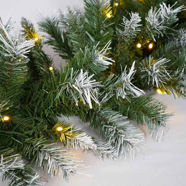 Frosty Christmas garland with lights on a white background