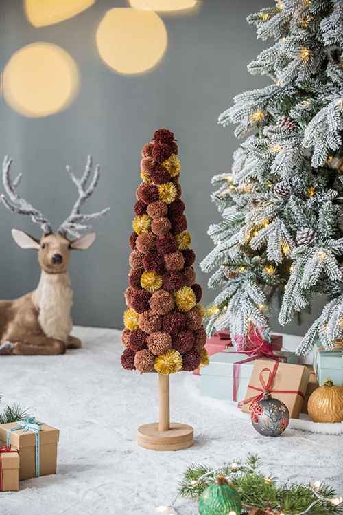 Christmas tree table decor beside a deer figurine