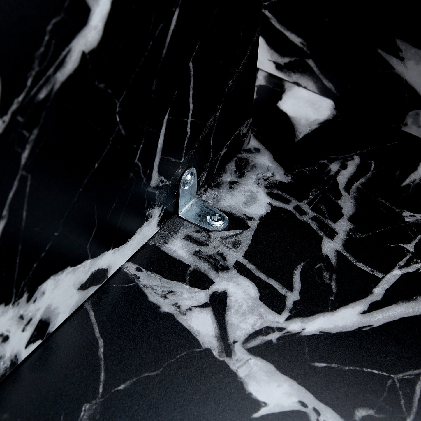 Interior bracket of black MDF round coffee table with modern minimalism, showing secure metal hardware for stability.