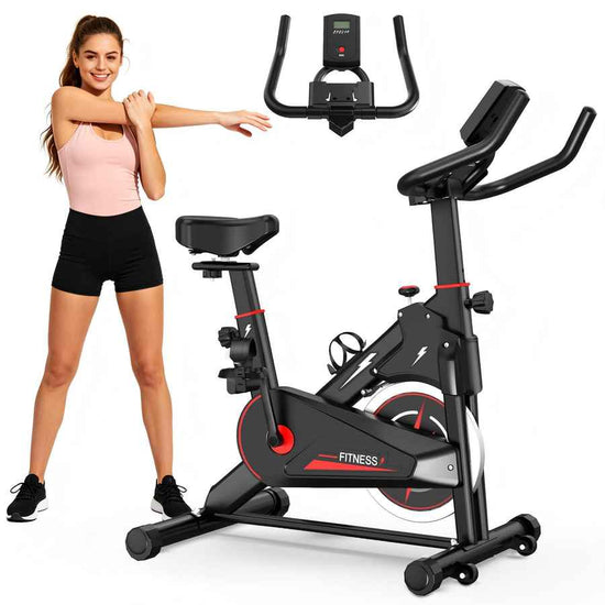 Woman standing next to a black and red exercise bike on a white background