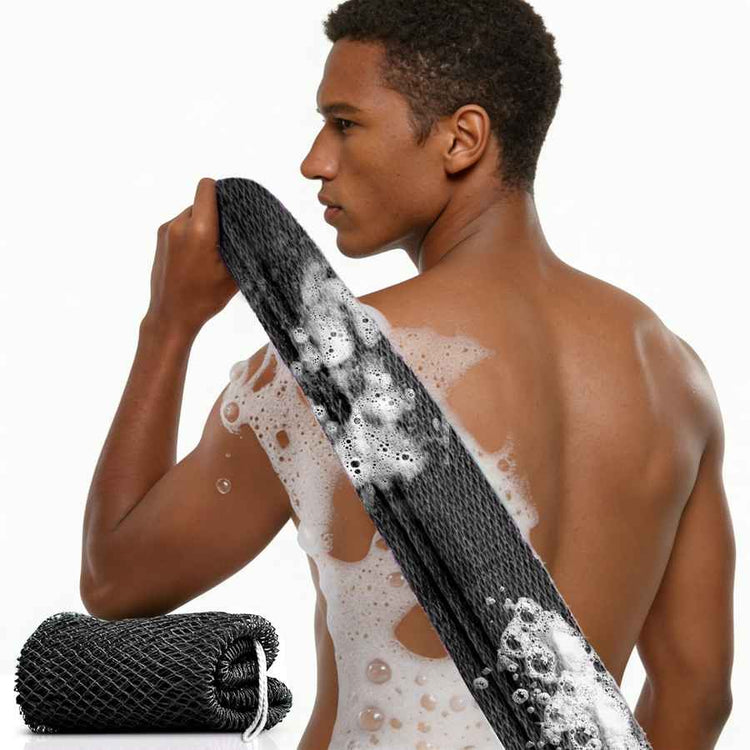 Man with soap suds on his back holding a black mesh scrubber.