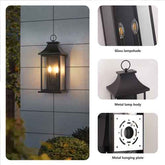 Outdoor wall light fixture with glass lampshade and metal body, installed on a wall.
