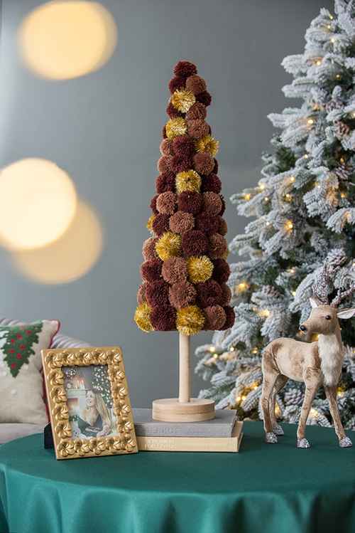 Christmas tree table decor on a teal tablecloth