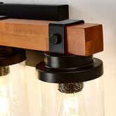 Close-up of a wall-mounted light fixture with wooden and metal design.