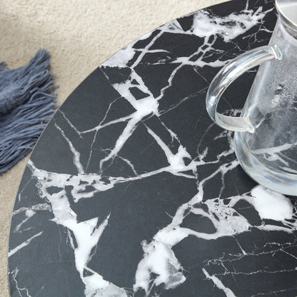 Close-up of black MDF round coffee table surface with white marble veining, highlighting its modern minimalist texture.