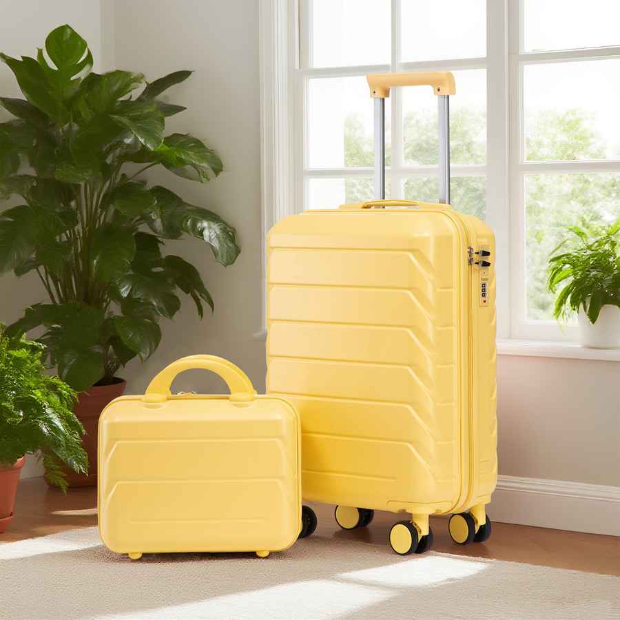 Interior shot of yellow ABS spinner luggage set with 14-inch and 20-inch suitcases in a bright room with plants and sunlight