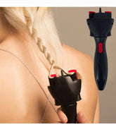 Black and red hair straightening tool held by a person with blonde hair.