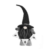 Black and white gnome figurine with a long hat on a white background
