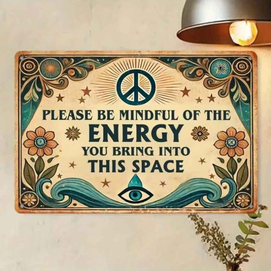 Decorative sign with peace symbol, flowers, and text on a wall.