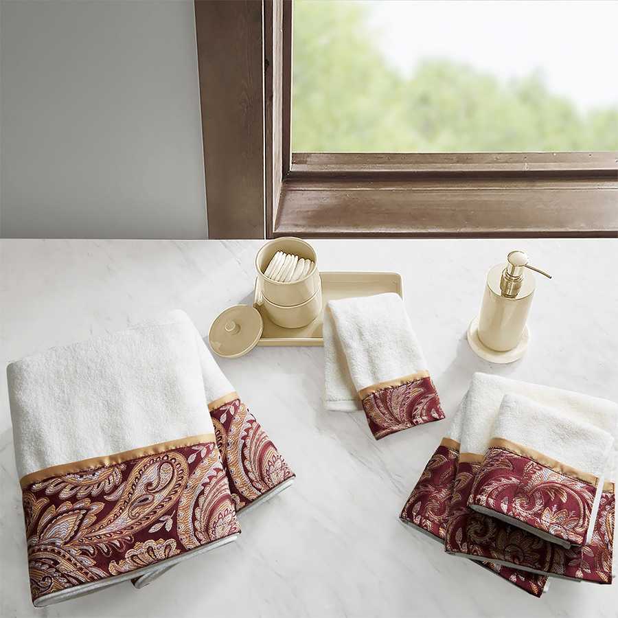 6 Piece Jacquard Towel Set in burgundy with paisley border, displayed in an elegant bathroom setting. Made of 100% cotton and machine washable.
