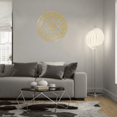 CIFbuy Sacred Mandala Wall Art in gold aluminum on a light gray wall above a modern sofa. Adds serene charm to contemporary living rooms.