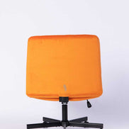 Back view of the Orange Velvet Office Chair highlighting its sleek, minimal design and sturdy rolling base.