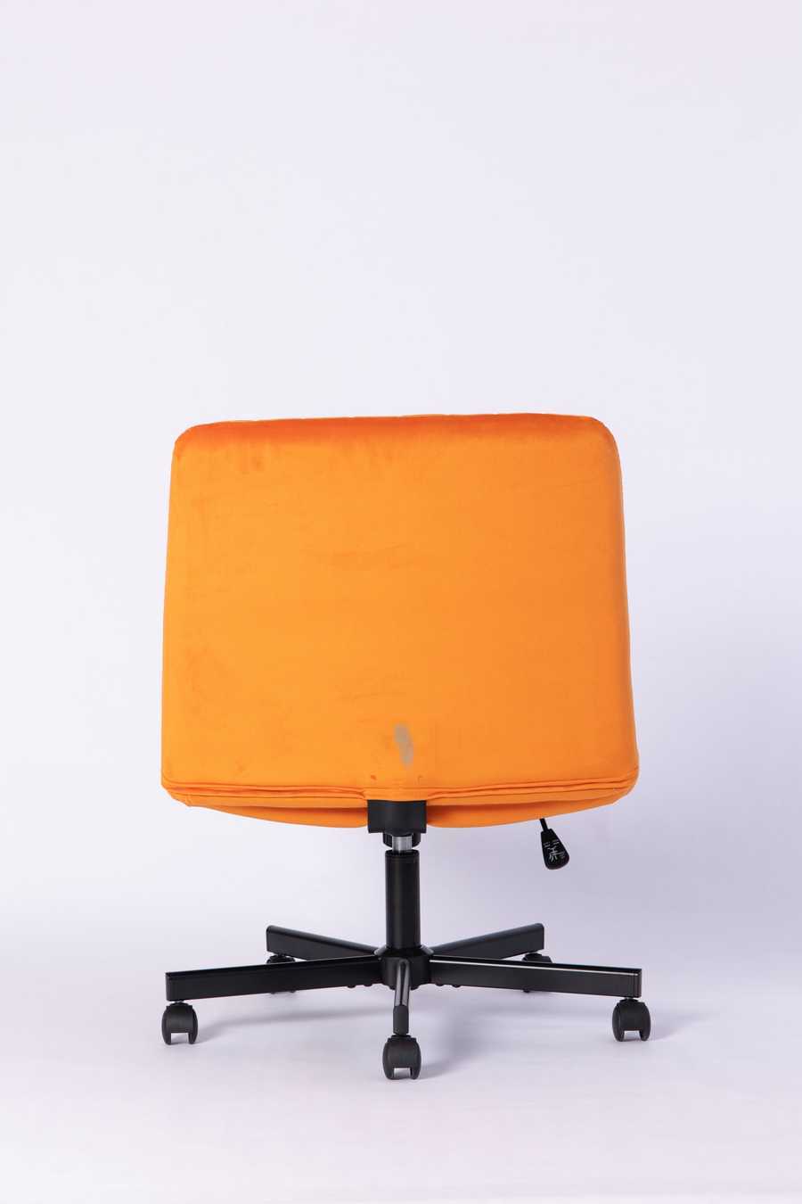 Back view of the Orange Velvet Office Chair highlighting its sleek, minimal design and sturdy rolling base.