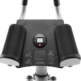 Close-up of a black and silver exercise device with control panel on a white background