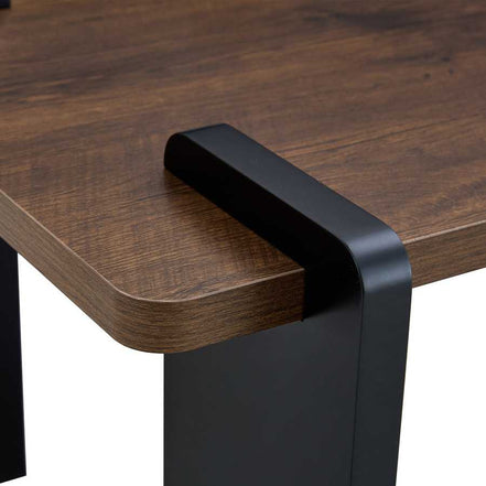 Rounded corner and black leg detail of Walnut MDF Coffee Table, highlighting its smooth finish and modern design elements.