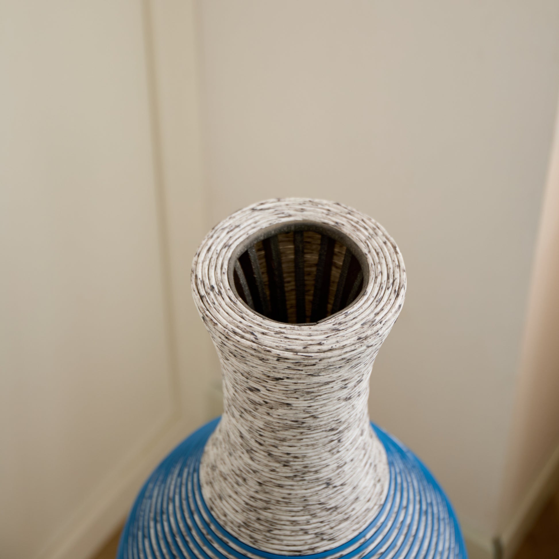 Top view of 39-inch floor vase decor showcasing its narrow opening and detailed PVC craftsmanship. Great for dried floral arrangements.