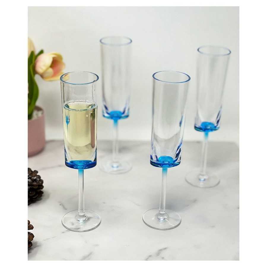 Unbreakable Champagne Flutes Set of 4 in blue acrylic, displayed on a marble surface with one filled with champagne, ideal for parties.