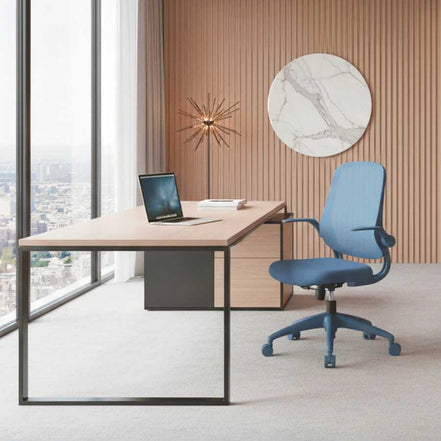 Modern office desk with a blue chair in a room with large windows and decorative wall art.