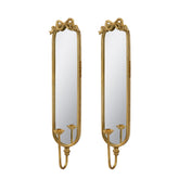 A pair of tall, narrow wall mirrors with ornate gold frames and decorative scrollwork at the top, shown against a plain white background.