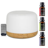 White diffuser with wooden base and essential oil bottles on a white background