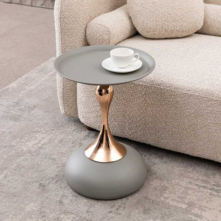 Mermaid Tail Coffee Table - Modern Metal round side table with gold stem and matte grey top, placed beside a beige sofa in a cozy living room.