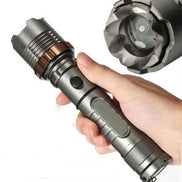 Close-up of rechargeable LED flashlight with zoom lens and rugged design. Built for hiking, camping, and emergency use.