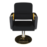 Close-up of black salon chair with gold accents and marble flooring