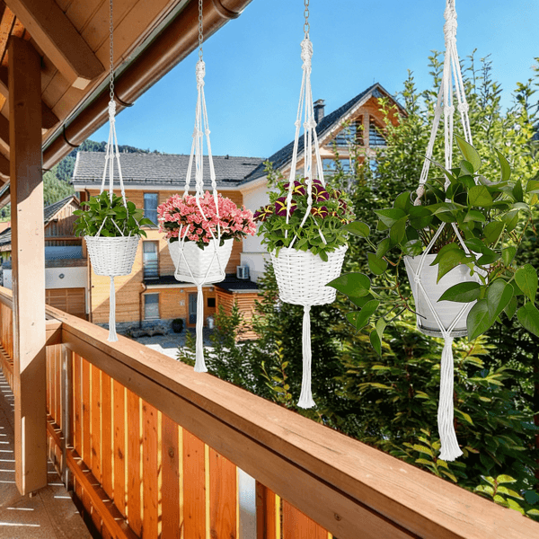 Close-up of white macrame plant hanger with green plant and hand-woven design