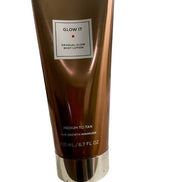 Glow It Gradual Glow Body Lotion Medium to Tan 6.7 fl oz in bronze tube with silver cap, ideal for self-tanning and skincare routines.