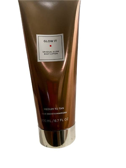 Glow It Gradual Glow Body Lotion Medium to Tan 6.7 fl oz in bronze tube with silver cap, ideal for self-tanning and skincare routines.