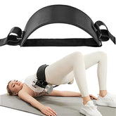 Black exercise belt being used by a person on a mat