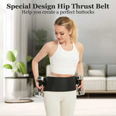 Woman wearing a black hip thrust belt while holding dumbbells in a home setting.