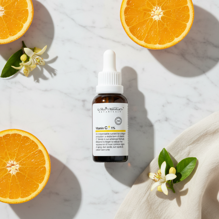 Vitamin C Brightening Serum lifestyle flat lay on marble with citrus slices and yellow flowers