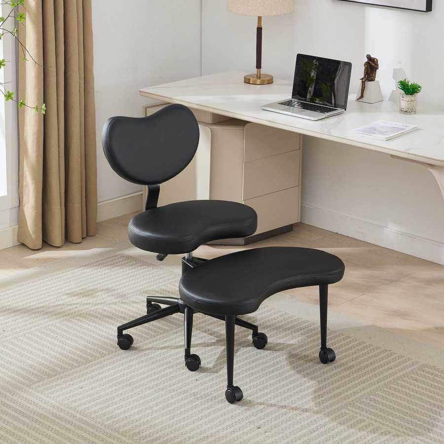 Black ergonomic chair in a home office setting with a desk and lamp.