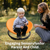Toddler playing on MLNshops Sensory Swivel Chair outdoors with parent, promoting sensory development and bonding time.